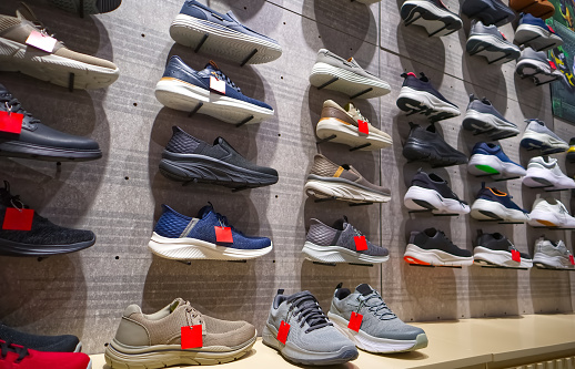 Sneakers on the shelves in the shoe corner in Department Store, Bangkok, Thailand