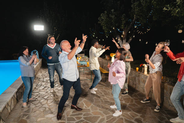 istock Multiracial and multi-generation families, dancing during family reunion 1695351149