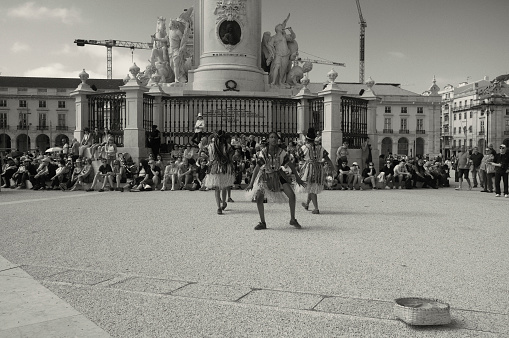 Lisbon, Portugal - May 21, 2022: A group of african dancers performs at the Praça do Comércio square in Lisbon downtown.