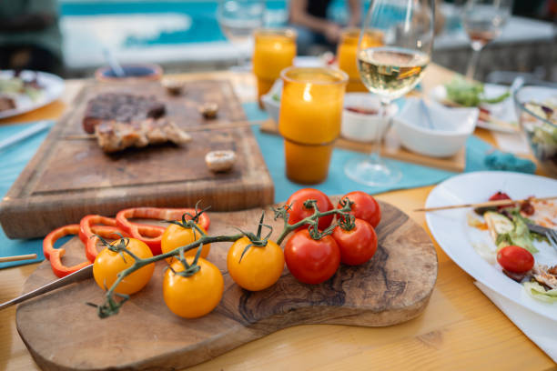 istock Salad, barbecue and messy plates on the table during an brunch 1695365686