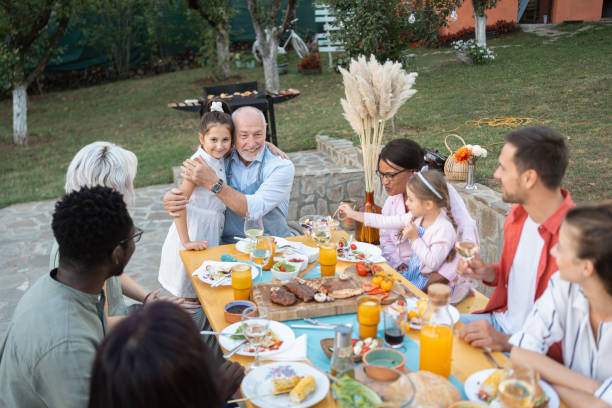 istock Multiracial and multi-generation families enjoying family brunch 1695366624