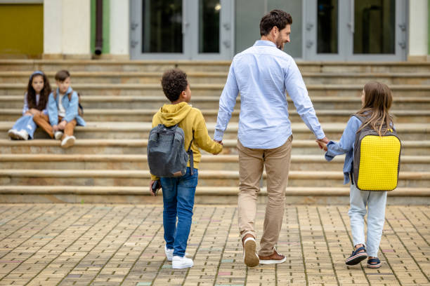 istock Father taking kids to school in the morning 1695372242