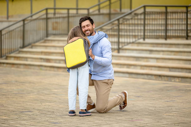 istock Dark-haired man sending his daughter to school 1695372259