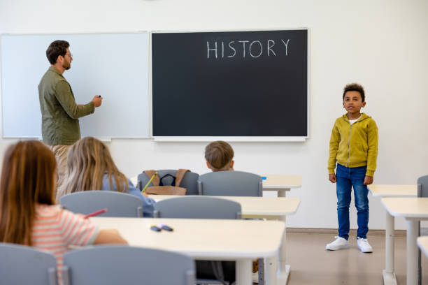 istock Teacher introducing a new boy to the classmates 1695372300