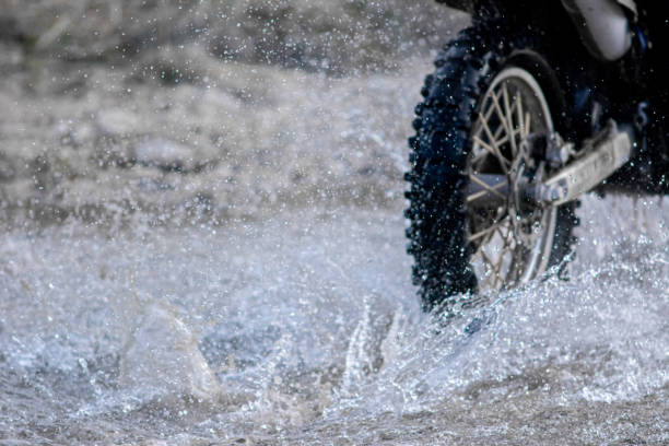 istock Motocross ride through a mountain stream at dusk 1695379490