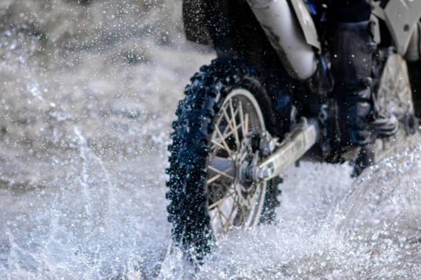 istock Motocross ride through a mountain stream at dusk 1695379501