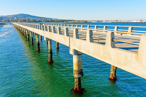 Close-up side view of the concrete structure of the Cabrillo Beach Pier in Long Beach, California.