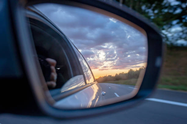 istock Sunset in car mirror, reflection from the nature 1695425649