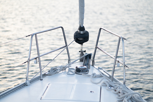 Yachting. Sailing yacht nose view on sea background