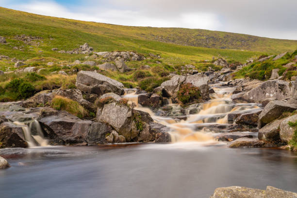 istock Waterfall in the fields of Wicklow mountain 1695447906