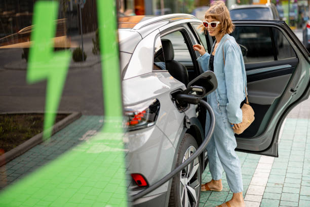 istock Woman charging electric car while shopping 1695448517