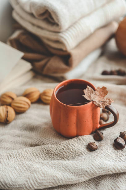 istock Cup of hot tea and a leaf, autumn mood 1695454791