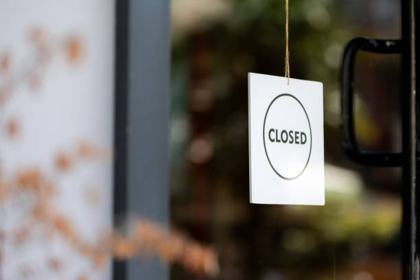 istock Store closed sign hanging on the window. 1695471026