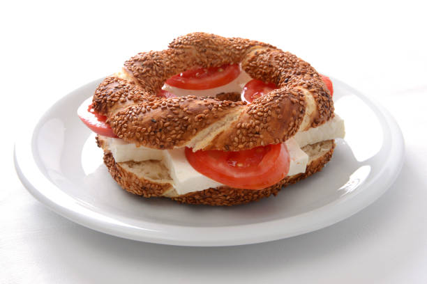 traditional Turkish bagel with kashkaval cheese and tomato ready for breakfast on a white background