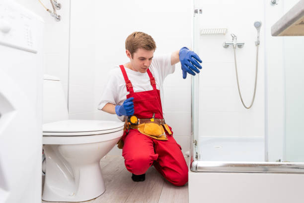 istock Plumber installing a shower cabin in bathroom 1695495189
