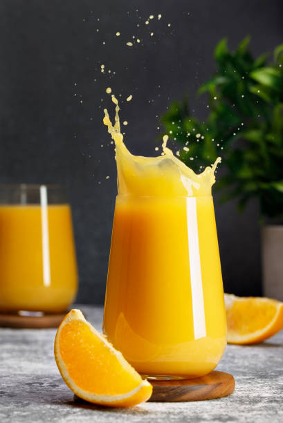 istock glass of orange juice with splash on table 1695497600