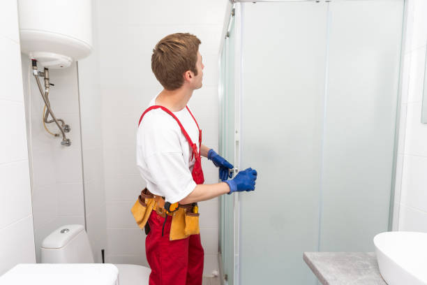 istock Plumber installing a shower cabin in bathroom 1695499863