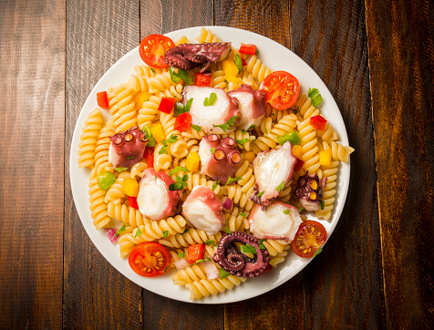 Pasta salad with octopus tomatoes and peppers