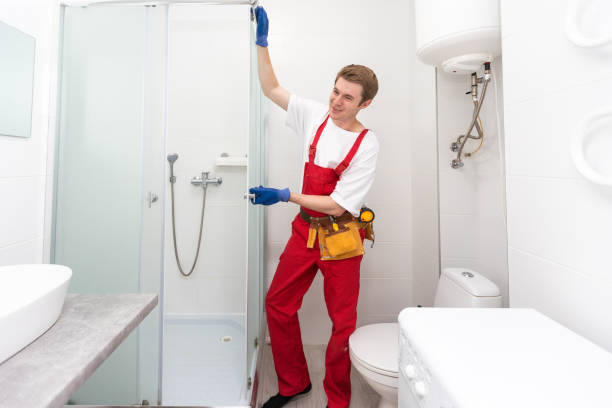 istock Plumber installing a shower cabin in bathroom 1695519280