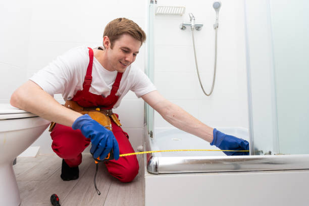 istock repairmen in uniform measuring modern shower cabin in bathroom 1695519962
