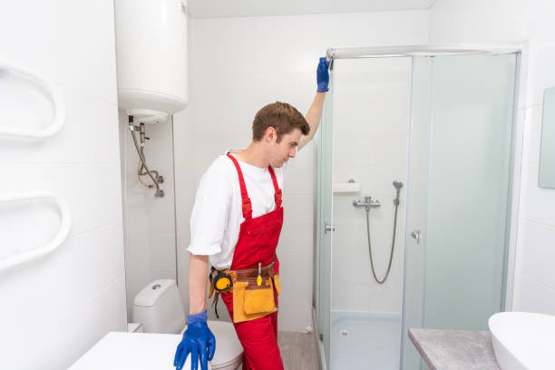 istock Plumber installing a shower cabin in bathroom 1695520519