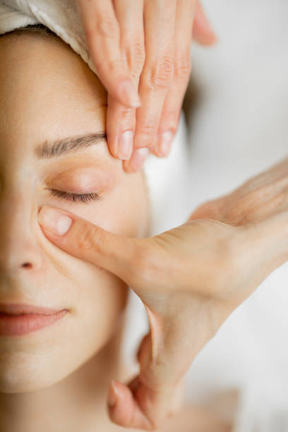 istock Beautician makes a face massage for a woman 1695520572