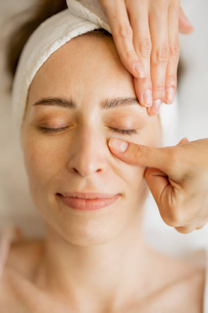 istock Beautician makes a face massage for a woman 1695521110