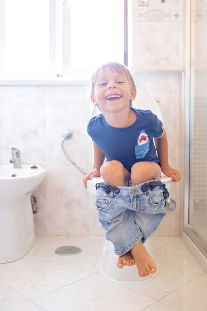 istock Cute child, boy, sitting on the toilet 1695522256