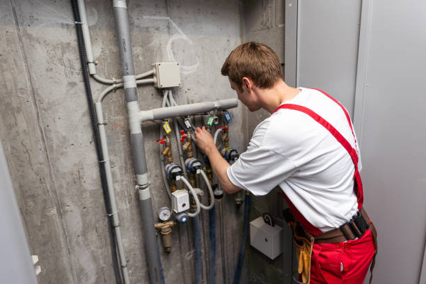 istock maintenance - technician checking pressure meters for house heating system. 1695523387