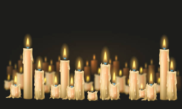 istock A glowing candles with melted wax. Composition of burning candles on dark background. 1695529331
