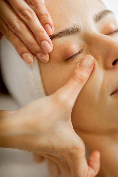 istock Beautician makes a face massage for a woman 1695540852