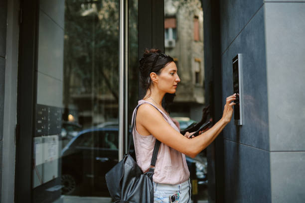 istock woman locking - unlocking smart building entry 1695552234
