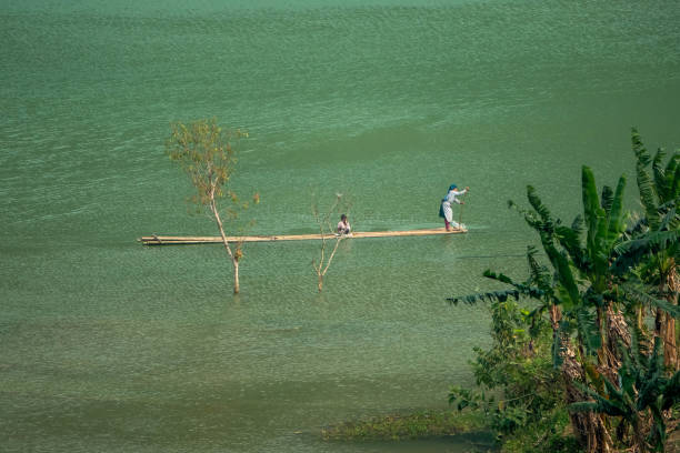 Two people in a very simple canoe in North Vietnam