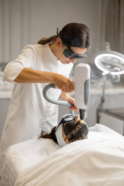 istock Cosmetologist makes laser carbon peeling 1695563560