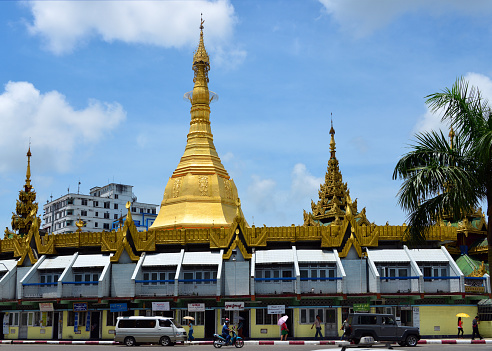 Yangon / Rangoon, Myanmar / Burma: Sule Pagoda, at the center of the roundabout at the intersection of Maha Bandula Road and Sule Pagoda Road - The Sule pagoda or paya is a temple located in a round-about in downtown Yangon. The pagoda is distinguished from the rest because the octagonal shape of the base is carried over to the golden dome. During the British period, the city center was completely restructured and the pagoda served as the center. Since then, Sule Paya has served as a reference for kilometer distances to the north of the country. The temple has four entrances, oriented towards the four cardinal points. According to tradition, some Buddha 's hair is preserved inside.