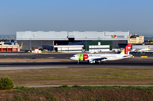 Lisbon, Portugal: TAP Maintenance and Engineering facility, the main hangar - TAP Air Portugal Airbus A320-214 (registration CS-TNK, MSN 1206) taking-off - Humberto Delgado Lisbon International Airport. TAP Air Portugal is the flag carrier of Portugal and a Star Alliance member, headquartered at Lisbon Airport which also serves as its hub. TAP Maintenance & Engineering is TAP's maintenance, repair and operations (MRO) organization, providing services for Airbus, Boeing and Embraer fleets. TAP M&E serves TAP's fleet as well as civilian and military clients worldwide, TAP is consistently one of the world's safest airline companies.