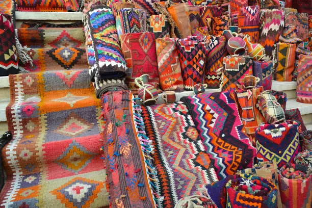 Photo of Colorful carpets, blankets and souvenirs exposed on the steps of a bazaar in Erbil, Iraq
