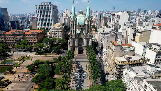 Panning wide of famous catholic church Metropolitan Cathedral of Sao Paulo at ground zero of downtown Sao Paulo Brazil located at Sé Square. Historic medieval building. Religion scenery.