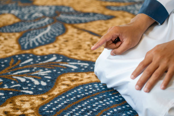 istock Muslim men praying in Tashahhud posture 1695592329