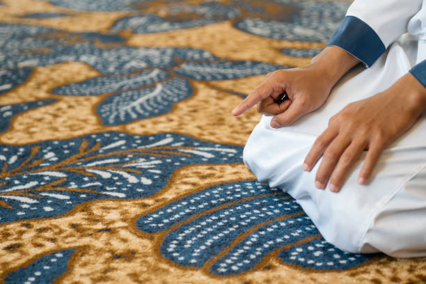 istock Muslim men praying in Tashahhud posture 1695592702