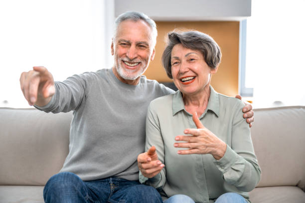 istock happy mature couple watching TV and have fun 1695596313