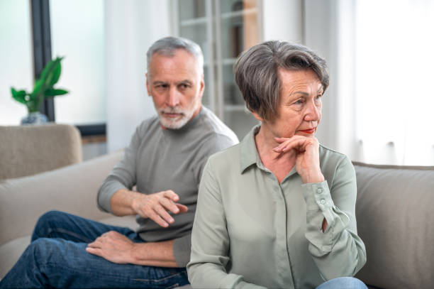 istock upset elderly woman offended at her husband and turned away 1695596314