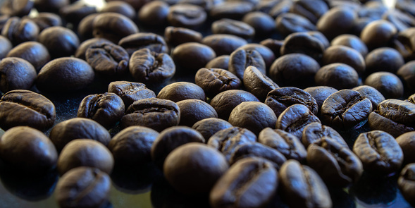 Close-up of roasted coffee beans with light exposed, shot with long exposure