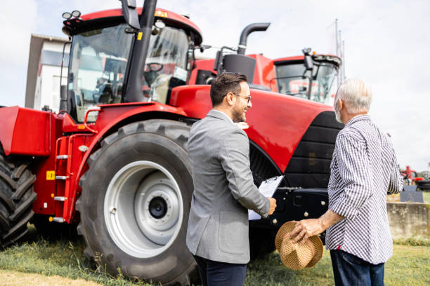istock Farmer buying tractor at agriculture fair. 1695627314