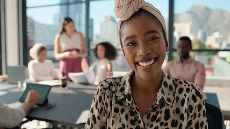 Face, smile and a black woman employee in meeting with her team for a planning or strategy workshop. Portrait, project management and a happy young business person in the office for a seminar