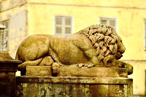 Stone lion statue with heraldic shield. Blue sky background, copy space. Perast town, Kotor Bay, Montenegro