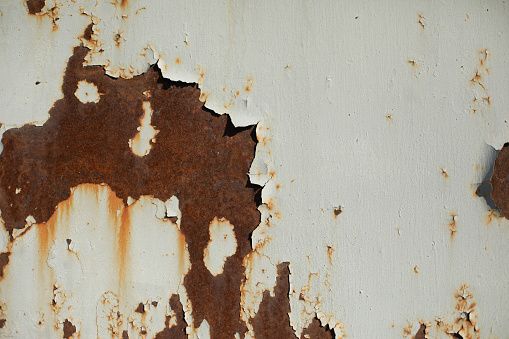 Rust on metal. Steel is rusted. Damaged surface. Brown spots.