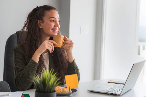 istock Business woman taking a coffee break and smiling 1695652358