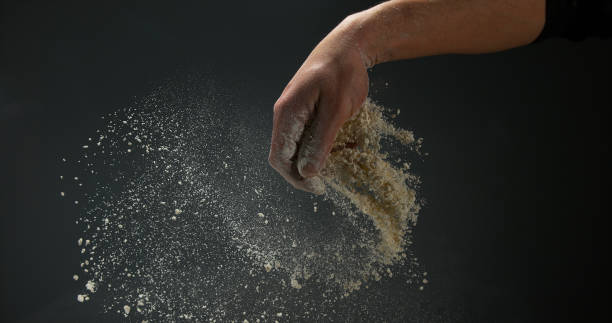istock Hands of Man with Flour against black background 1695668085