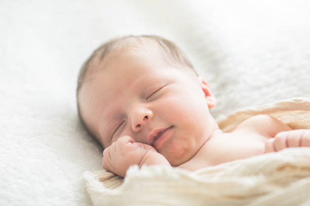 istock Cute baby sleeping 5 days old on light blanket. Banner design with space for text 1695669169